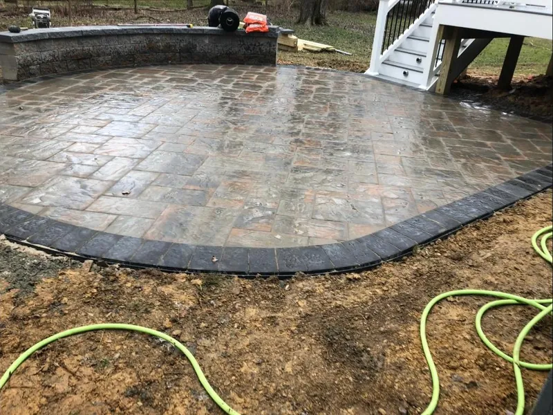 Round paver patio with deck stairs