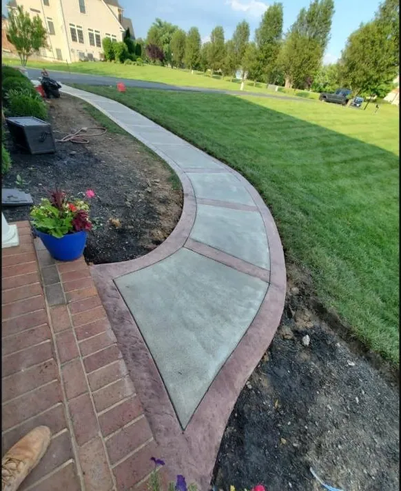 Stamped concrete walkway with brick border